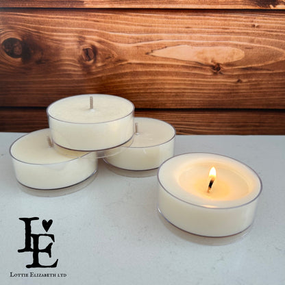 A lit Maxi Tealight emitting a warm glow, made from natural soy wax in a clear cup