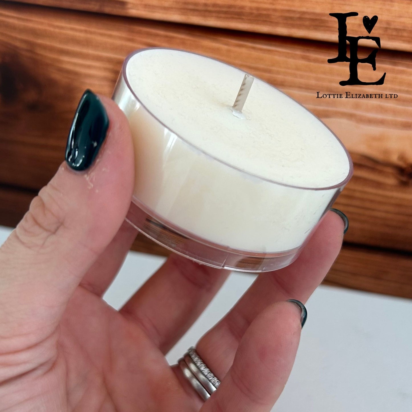 A Maxi Tealight in hand, showcasing its size and clear cup design, made from natural soy wax