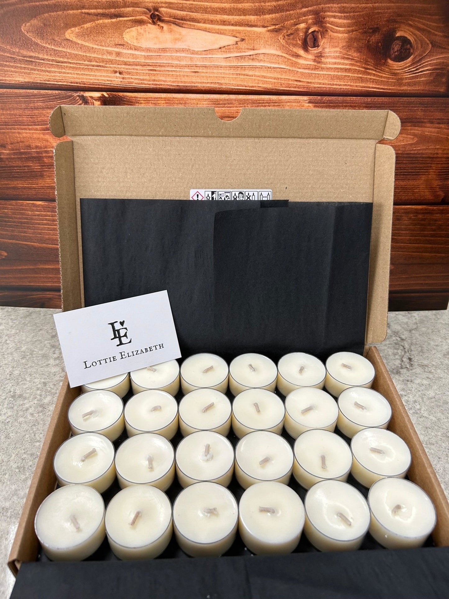 Image of our Lottie Elizabeth Ltd letterbox tea lights candles: Sustainably packaged. Perfect for weddings, events, and gifts. Made from natural soy wax. Keywords: tea light, tea lights, tealights, nature, soy wax, soywax, vegan, eco-friendly, unscented candle, 6, 12, 24. GLIMMA. Picture of 24 tea lights