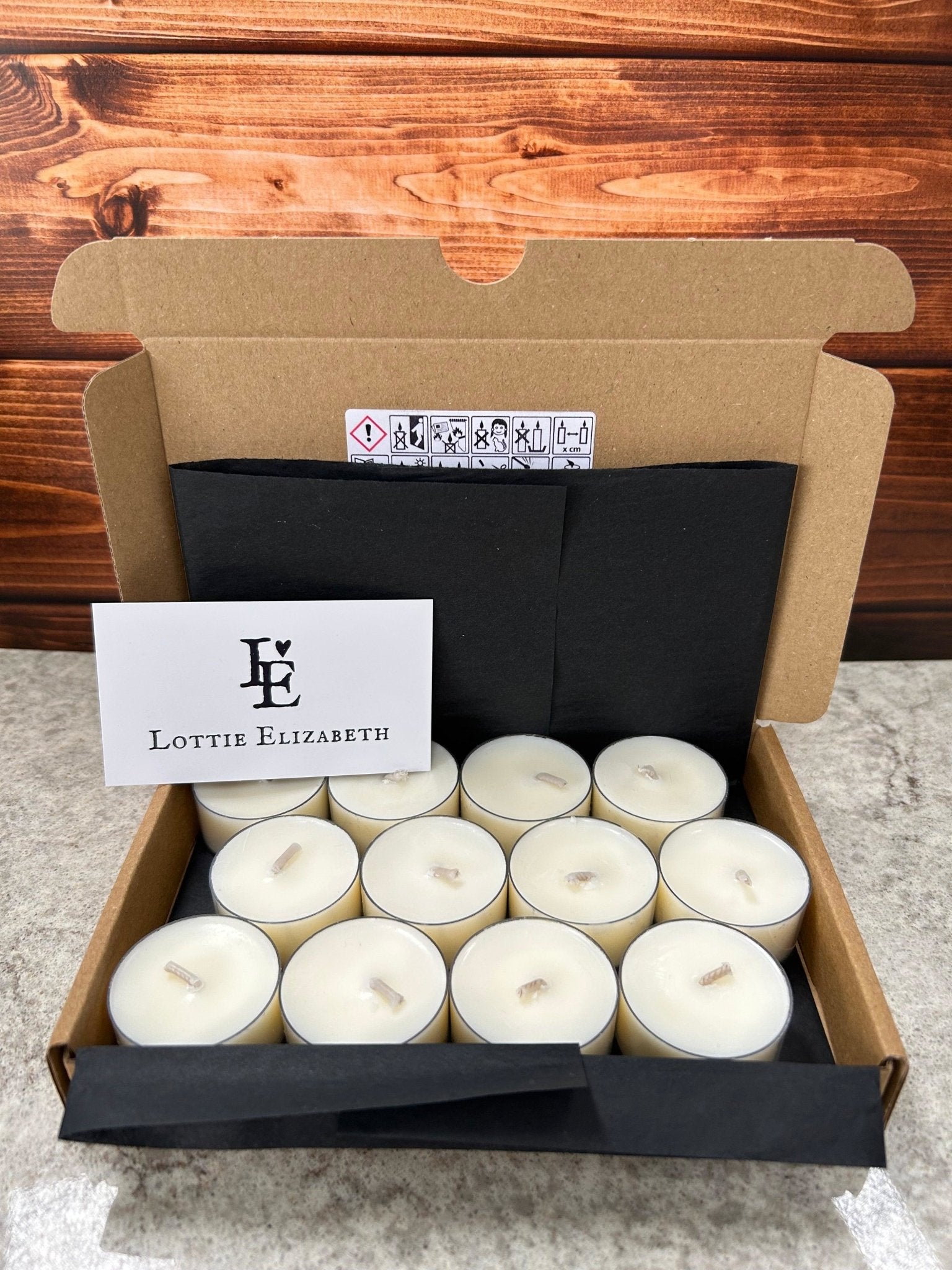 Image of our Lottie Elizabeth Ltd letterbox tea lights candles: Sustainably packaged. Perfect for weddings, events, and gifts. Made from natural soy wax. Keywords: tea light, tea lights, tealights, nature, soy wax, soywax, vegan, eco-friendly, unscented candle, 6, 12, 24. GLIMMA. Picture of 12 tea lights