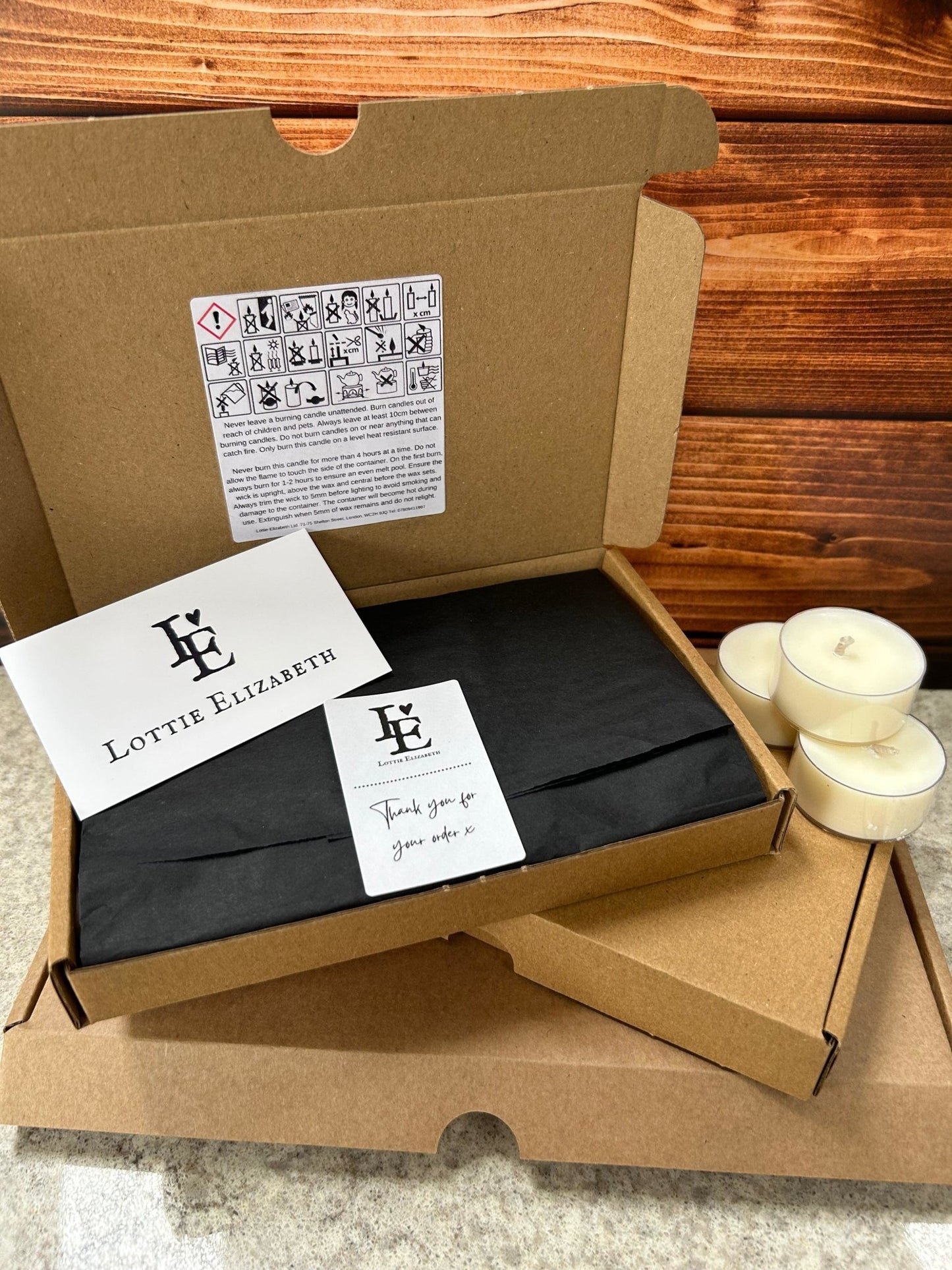 Image of our Lottie Elizabeth Ltd letterbox tea lights candles: Sustainably packaged. Perfect for weddings, events, and gifts. Made from natural soy wax. Keywords: tea light, tea lights, tealights, nature, soy wax, soywax, vegan, eco-friendly, unscented candle, 6, 12, 24. GLIMMA. Picture of 12 including thank you card and safety