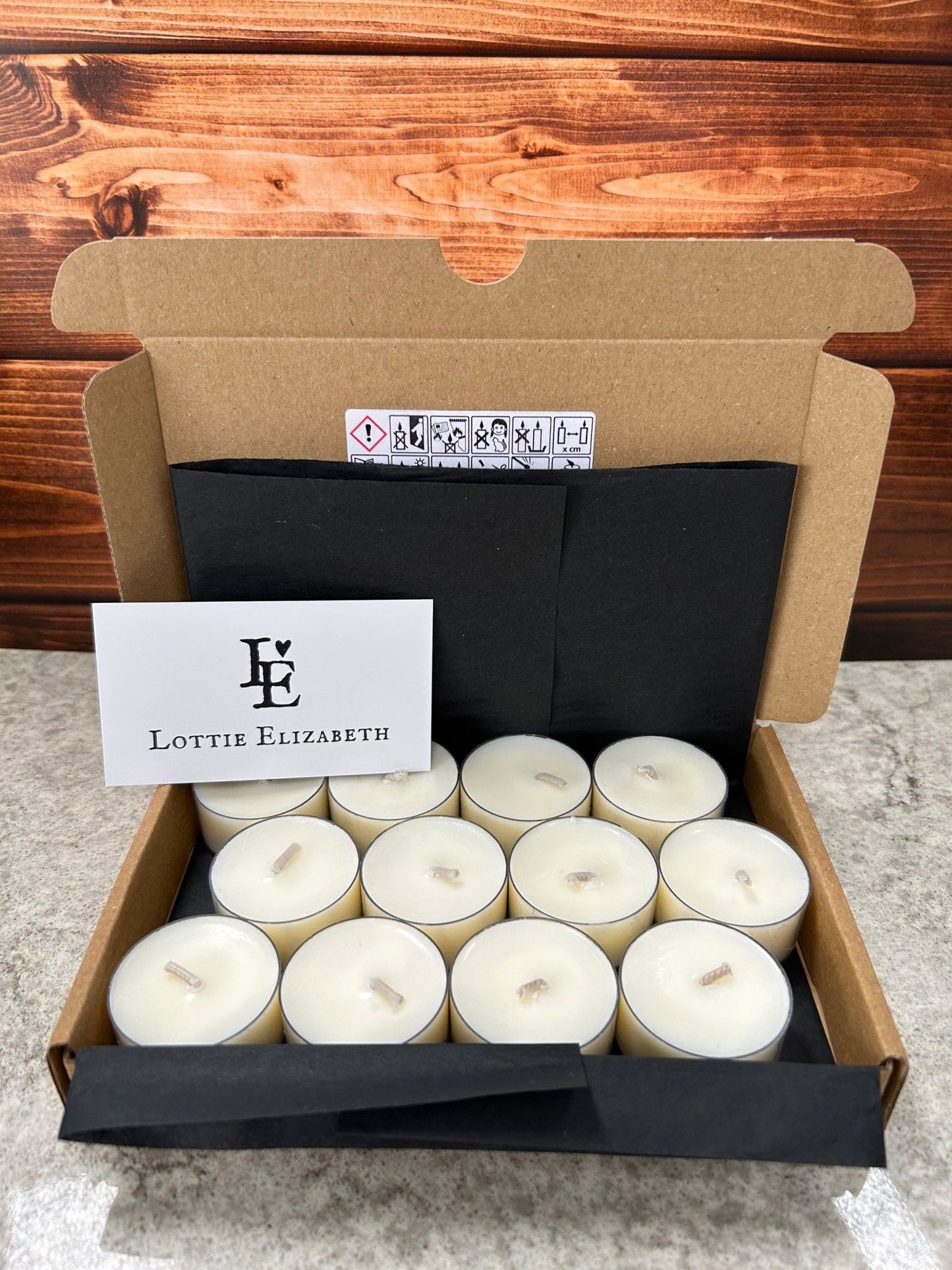 12-pack of natural unscented tealight candles with Lottie Elizabeth branding.